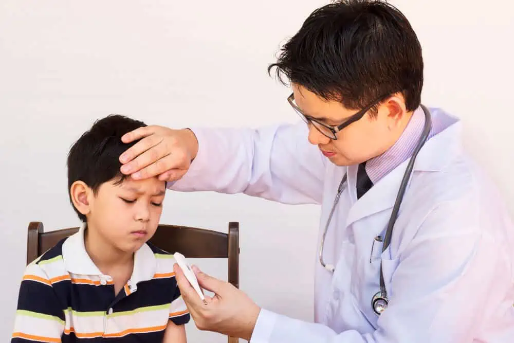 Doctor taking a child's temperature