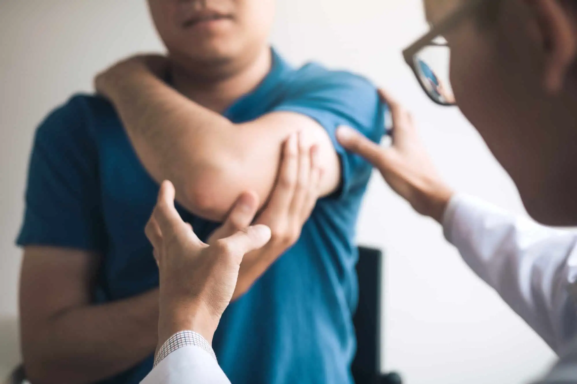 man with an elbow injury being examined